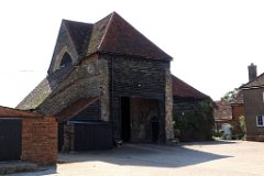 Latton Priory (Barn)  A round clerestory window, formerly sexfoiled, now blocked, survives in the north wall of the nave.  The nave was probably built before 1300. The crossing and transepts were built early in the 14th century, by which time the chancel had a north chapel. The nave was heightened around that time, and a lean-to building was added on the north side. : Church, Essex, Latton, Priory, C14