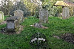 East Mersea - Sarah Wrench  Grave of Sarah Wrench on north side of East Mersea Church. She died 6 May 1848, aged 15 yrs 5 months. The grave is protected by an iron cage or mortsafe, which is normally used to stop grave-robbers. The grave is on the north side of the church - which in earlier centuries had been regarded as the 'Devil's side', used for the burials of excommunicants, suicides and the unbaptised. A story has evolved that the poor girl was a witch and that the cage was there to stop her leaving her grave after death. Although the last person to be incarcerated for witchcraft in Great Britain was in 1944, the witchcraft accusation seems to be a fanciful urban myth. A more likely explanation is that when she died (cause unknown), her body was given a place alongside the many relatives from the family Croyden who lived at East Mersea Hall and are interred in the same part of the church-yard.   The description of the cage as a mort-safe is also suspect. The Anatomy Act of 1832 had obviated the need for grave-robbing - allowing medical schools to get legal supplies of cadavers from the workhouses. As a durable strong material, iron was in fashion in Victorian times, and is frequently seen in local churchyards as gravemarkers. It is possible that this unusual iron construction was simply a 'modern' form of monument in the shape of the traditional bodystone. : Mersea, Island, Essex, beach, grave